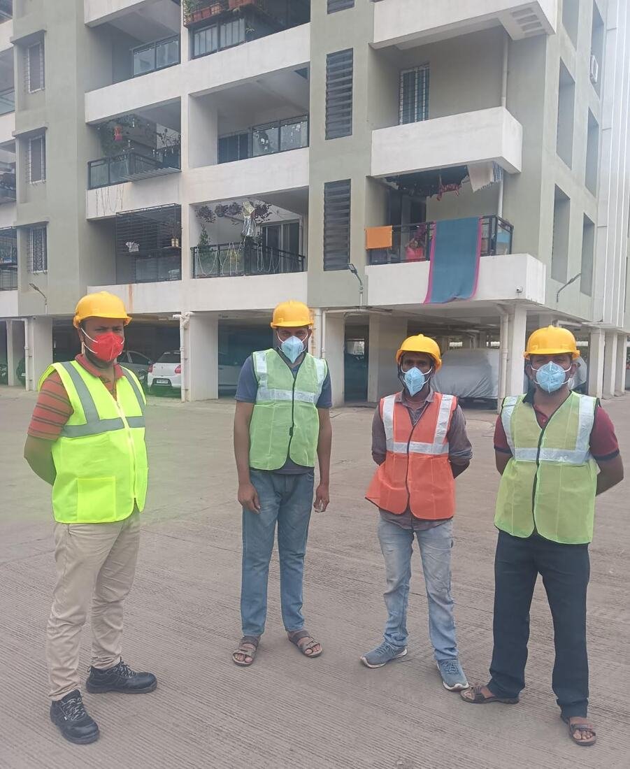 IFS site team in hard hats and safety vests outside a residential society in Pune